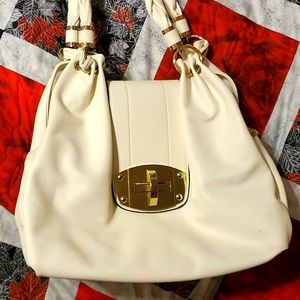 A off white with gold accent purse